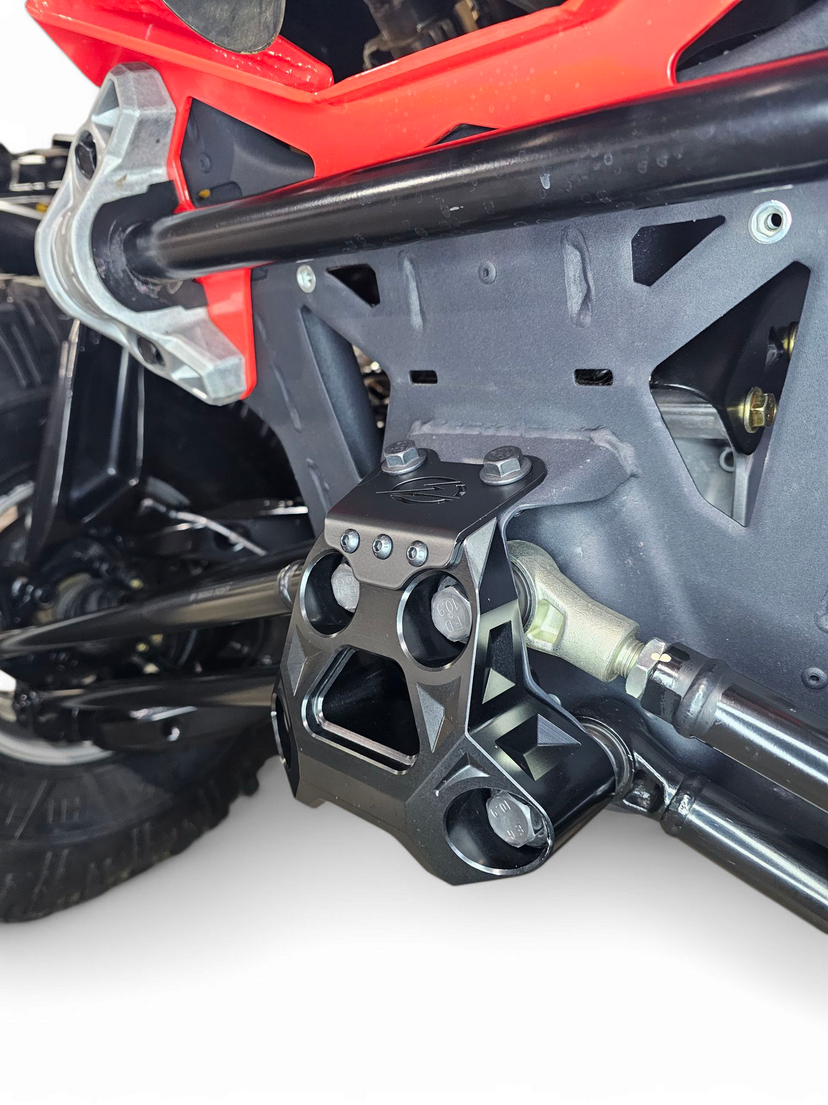Underside view of Can-Am Maverick R billet radius rod plate showing suspension protection coverage