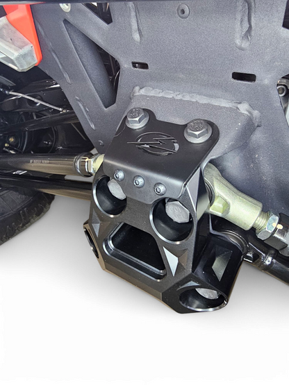 Close-up of CNC machining on Can-Am Maverick R black billet radius rod plate