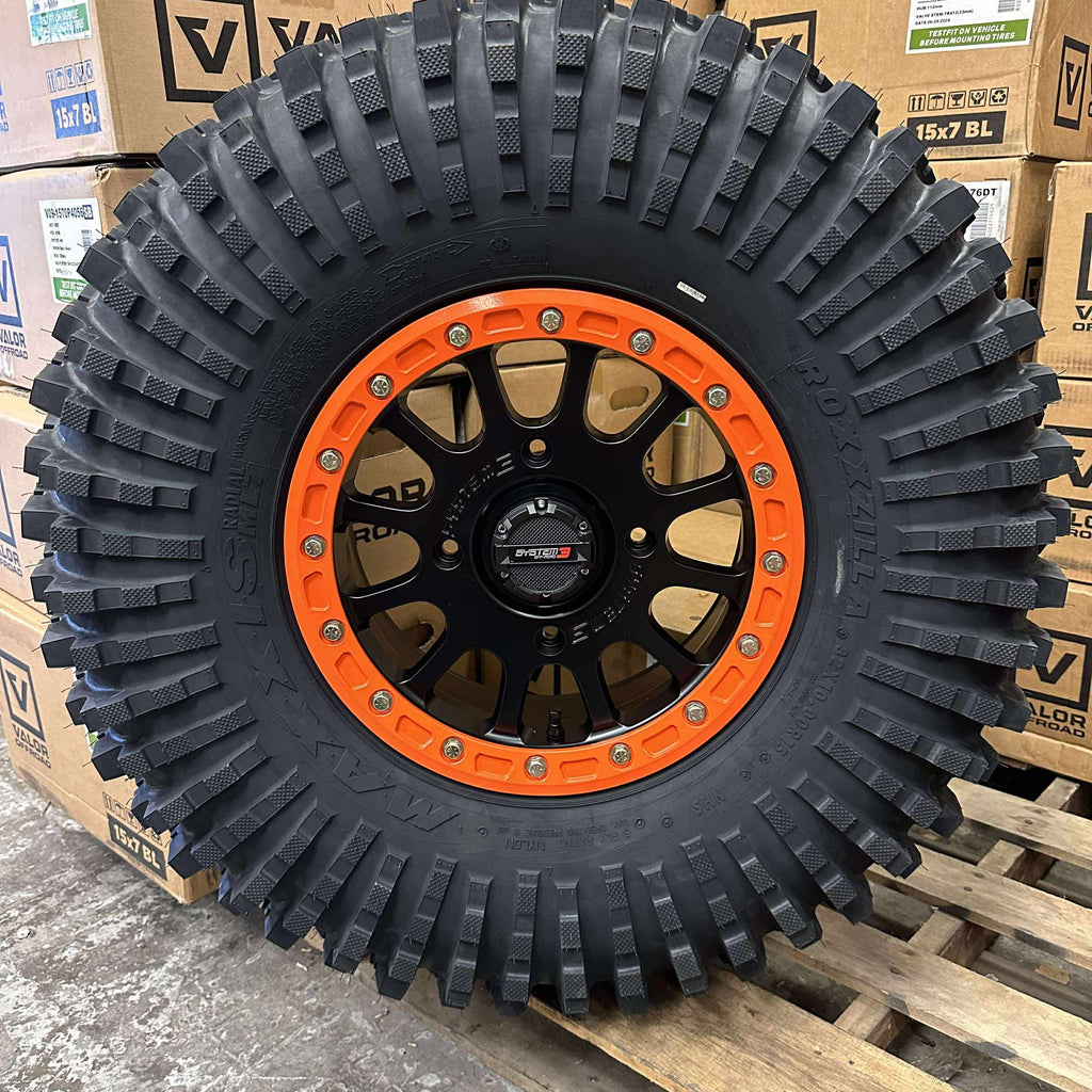 System 3 SB5 Beadlocks 4/156 Matte Black w/ Custom Orange rings mounted on Maxxis Roxxzillas