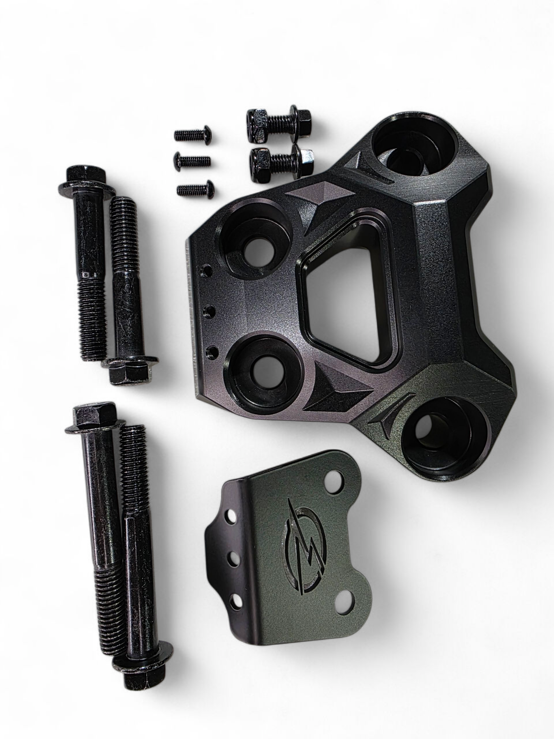 Rear suspension reinforcement detail on Can-Am Maverick R black billet radius rod plate