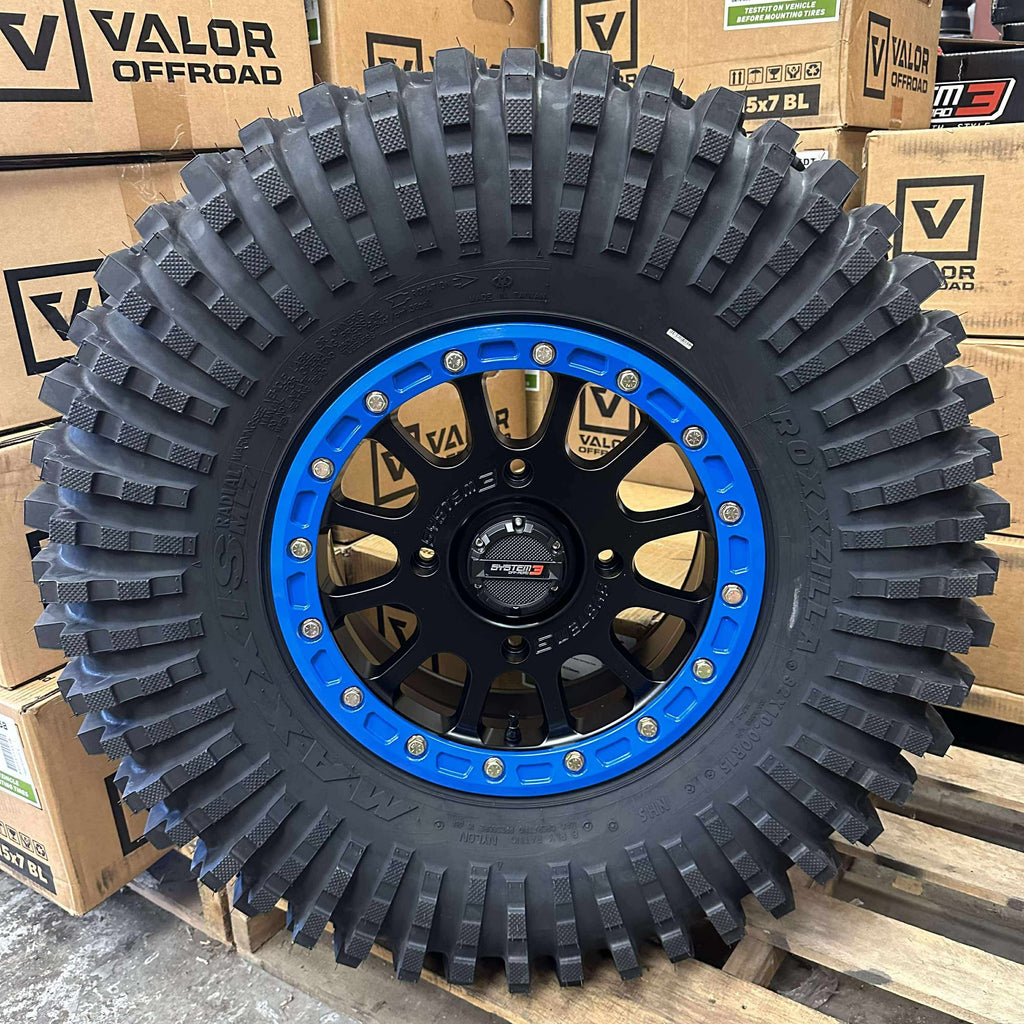 System 3 SB5 Beadlocks 4/156 Matte Black w/ Custom Blue rings mounted on Maxxis Roxxzillas